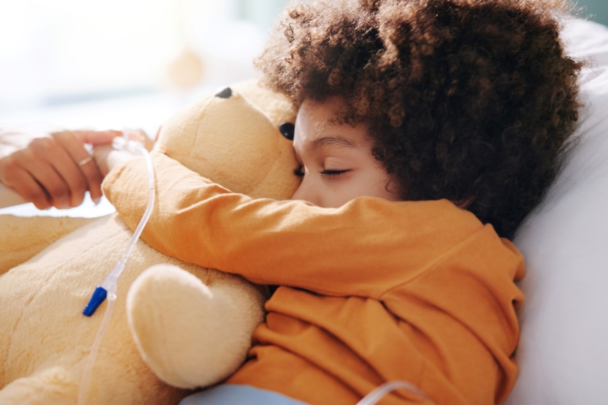 sick child hugging teddy bear