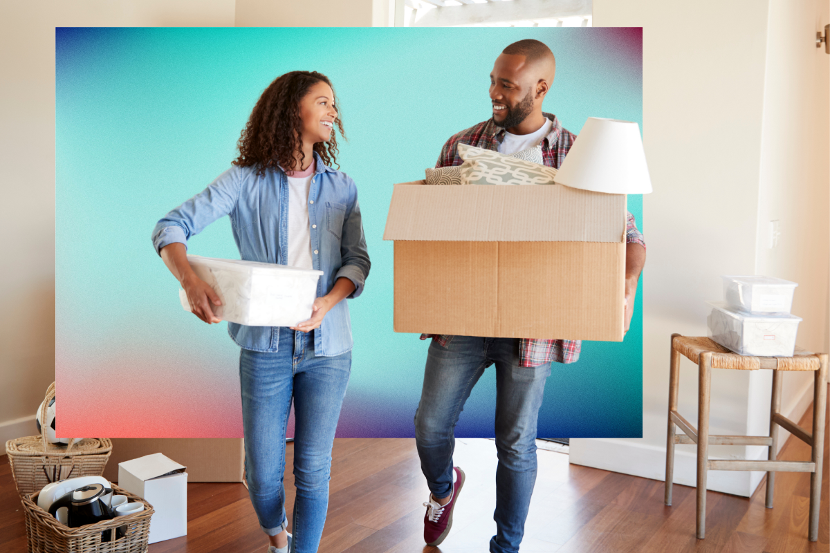 couple moving into a home and smiling at each other 