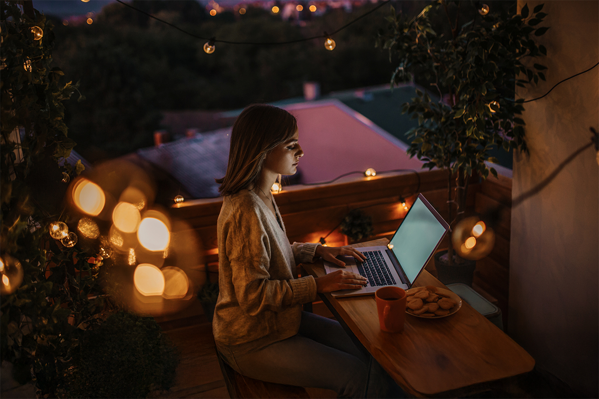 Woman working on laptop at night
