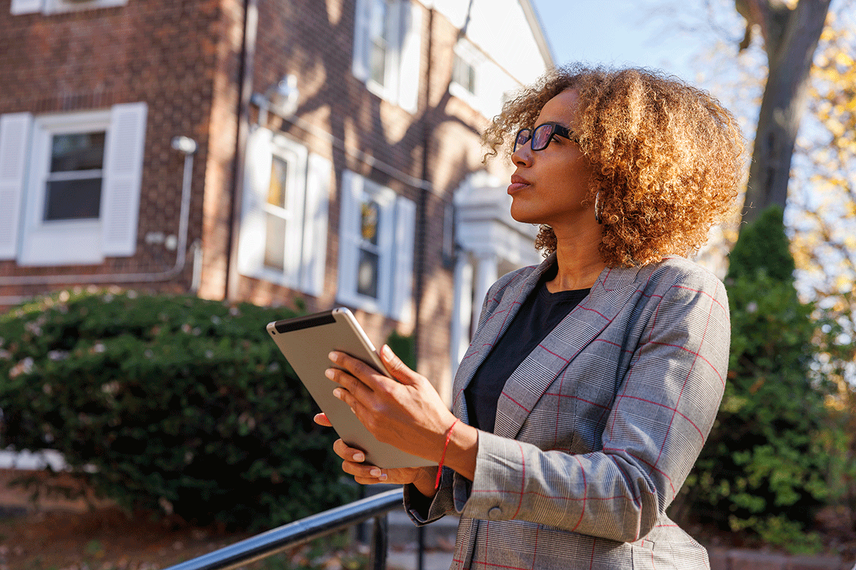woman evaluating home